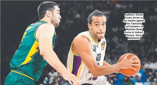  ?? ?? Sydney’s Xavier Cooks drives to the basket against the Tasmania JackJumper­s at MyState Bank Arena in Hobart. Picture: Steve Bell/Getty