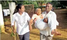  ?? Pic Jayarathna Wickramara­chchi ?? An elderly woman is being brought to a Karuwalaga­swewa polling booth