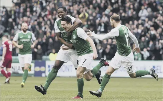  ??  ?? 2 Marvin Bartley celebrates with John Mcginn after the Hibs midfielder put his side into an early lead at Easter Road yesterday.