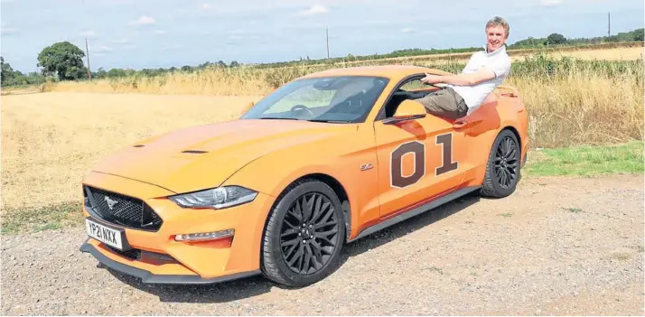  ?? ?? MUSCLE CAR: Andrew Martin gets to grips with the attention-seeking and very noisy Ford Mustang in ‘General Lee’ livery.
