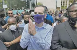  ?? Kent Nishimura Los Angeles Times ?? L.A. MAYOR Eric Garcetti, pictured Tuesday at a protest downtown, has said he will seek up to $150 million in cuts from the Los Angeles Police Department.