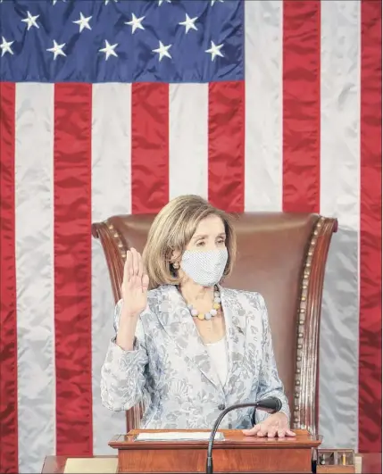  ?? Tasos Katopodis / Associated Press ?? House Speaker Nancy Pelosi takes her oath of office as the Speaker of the 117th Congress after being re-elected at the U.S. Capitol in Washington on Sunday.