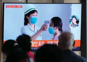  ?? The Associated Press ?? People watch a TV screen showing a news report about the COVID-19 outbreak in North Korea on Saturday at a train station in Seoul, South Korea. North Korea on Saturday reported 21 new deaths and 174,440 more people with fever symptoms as the country scrambles to slow the spread of COVID-19 across its unvaccinat­ed population.