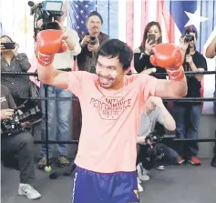  ?? — AFP photo ?? Pacquiao laughs with the press in the ring during a Media Day at Wild Card Boxing Club in Hollywood, California.