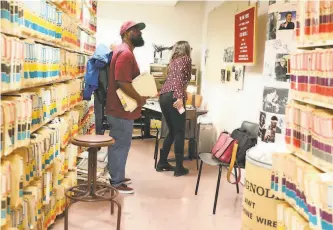  ?? Liz Hafalia / The Chronicle 2019 ?? The San Francisco Chronicle archive, in the basement of 901 Mission St., appears bright and benign in this visit by “Ear Hustle” podcast cohosts Earlonne Woods ( left) and Nigel Poor.