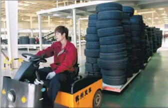  ?? DONG NAIDE / FOR CHINA DAILY ?? A worker drives a cart loaded with tires at Wanda Rubber Co Ltd in Dongying, Shandong province.