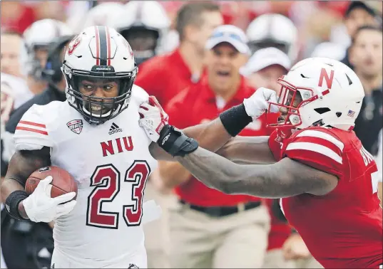  ?? [NATI HARNIK/THE ASSOCIATED PRESS] ?? Northern Illinois running back Jordan Huff is pushed out of bounds by Nebraska linebacker Mohamed Barry during the first half Saturday in Lincoln. Huff ran for 105 yards on 16 carries and scored the winning touchdown in the fourth quarter.