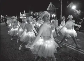  ?? TIM COOK/THE DAY ?? Santa and Mrs. Claus wave from Niantic’s antique fire during the 2016 Niantic Light Parade. Dancers from All the Right Moves Dance Center light up the night at last year’s Niantic Light Parade.