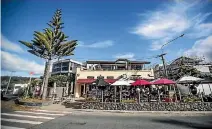  ?? PHOTO: GEORGE HEARD/STUFF ?? The Norpolk pine tree outside Sumner’s Black Bird Bar and Cafe has been trimmed, sparking controvers­y.