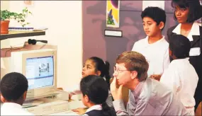  ?? File photo ?? Bill Gates looks over computer work by students in a third-grade classroom 20 years ago.