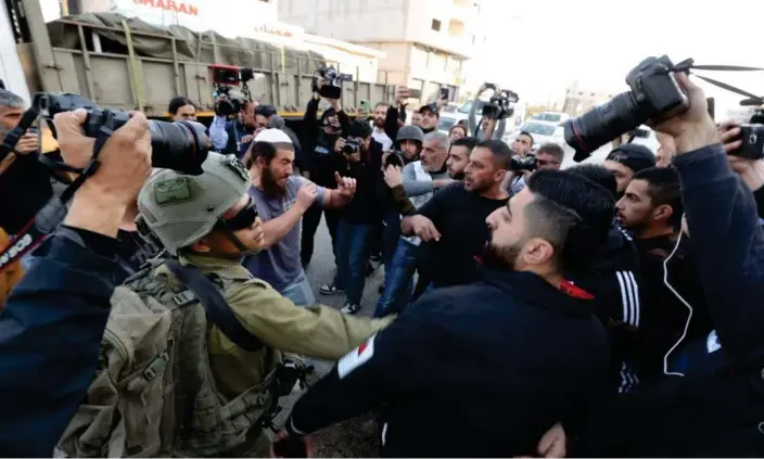  ?? Photograph: Anadolu Agency/Getty Images ?? Tension rises between Jewish settlers under the protection of Israeli forces and Palestinia­ns in the northern West Bank town of Huwara.