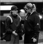  ?? ASSOCIATED PRESS ?? IN THIS FEB. 16, 2019, FILE PHOTO, Rutgers head coach Kristen Butler (right) argues a call with the home plate umpire during a game against Texas A&M in College Station, Texas.