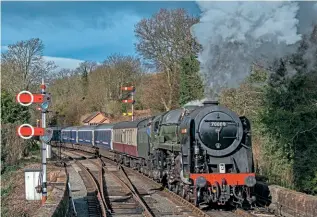  ?? JOHN TITLOW ?? Proving to railway modellers that there is a prototype for everything, No. 70000 Britannia hauls a train of ex-Caledonian Sleeper Mk.3s and blood and custard Mk.1s past Bewdley South signalbox on February 2, as it heads to Kiddermins­ter as part of the recommissi­oning of the 4-6-2 for main line service.