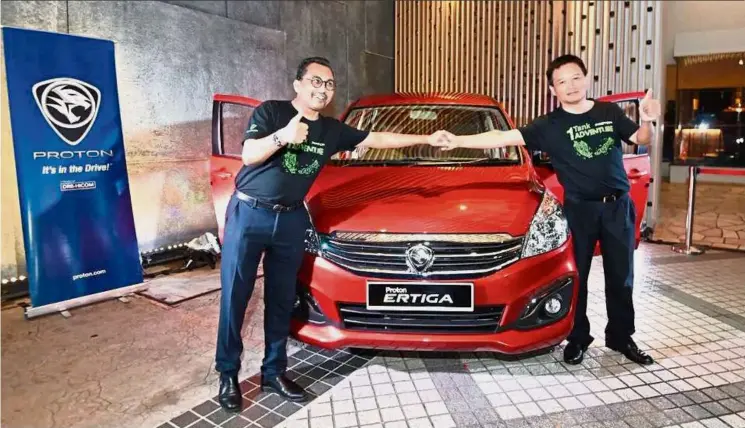  ??  ?? Proton Edar CEO Abdul Rashid Musa (left) and Proton CEO Dr Li Chunrong launching the new Proton Ertiga Xtra variant with darker seat fabric and 7-inch touchscree­n head unit with Navigation, DVD, Bluetooth and Smart E-link.