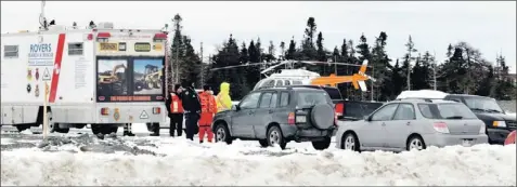  ?? — Photo by Gary Hebbard/the Telegram ?? RNC, Rovers Search and Rescue and a helicopter are seen on Stavanger Drive in the east end of St. John’s Tuesday as they search for Joshua Miller, missing since Friday.