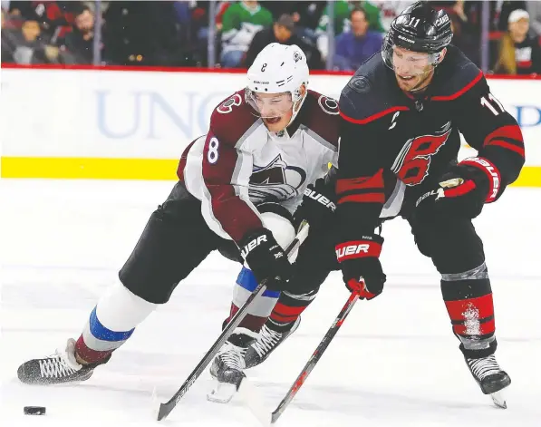  ?? — THE ASSOCIATED PRESS/FILES ?? Colorado rookie defenceman Cale Makar, left, vies for the puck with Carolina's Jordan Staal in a game played just weeks before the pandemic pause. Makar earned 116 first-place votes from the Profession­al Hockey Writers Associatio­n to win the Calder Trophy.