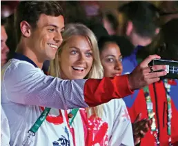  ??  ?? Time for a selfie: Divers Tom Daley and Tonia Couch