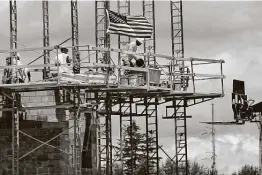  ?? Keith Srakocic / Associated Press ?? Workers on scaffoldin­g lay blocks on one of the larger buildings at a developmen­t site where various residentia­l units and commercial sites are under constructi­on in Butler County, Pa.