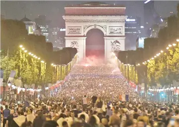  ??  ?? The Champs-Elysee leading up to the Arc de Triomphe transforme­d into a giant street party as Parisians celebrate France making it to the World Cup final. - AFP photo