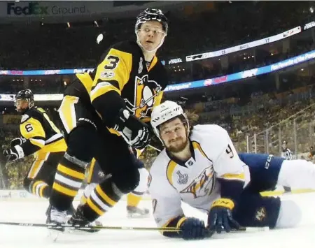  ?? GREGORY SHAMUS/GETTY IMAGES ?? Penguins defenceman Olli Maatta takes down Filip Forsberg of the Predators during a physical Game 2 of the Stanley Cup final.