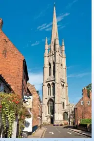  ??  ?? St James’ tower and spire, topped by a weathercoc­k in 1515, looms into view from Main Street, Louth.