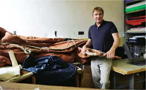  ??  ?? Top left One of the industrial sewing machines used for sailmaking.Top right A protective leather palm is worn while roping. Right Mark Butler in his workshop. Interview by Rachel Matthews. Photograph­s by Sean Dooley