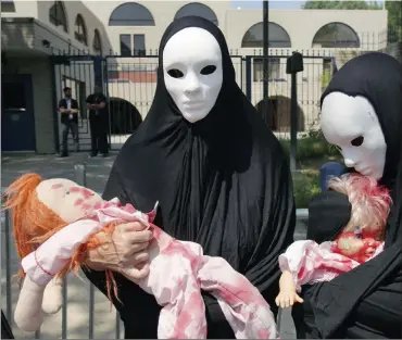  ?? Picture: REUTERS ?? SUFFER THE CHILDREN: Codepink activists, dressed to symbolise those wounded and killed in Gaza, under bombardmen­t from Israeli forces, rally outside the Israeli embassy in Washington.