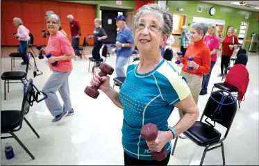  ?? NWA Democrat-Gazette/DAVID GOTTSCHALK ?? Cherie Ressler participat­es in a Silver Sneakers exercise session Tuesday under the instructio­n of Cindy Mix at the Springdale Senior Activity and Wellness Center. The center will undergo a needs assessment to direct the future of the center.