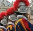  ??  ?? The famous Swiss Guards stand at attention near St Peter’s Basilica.