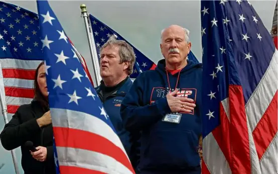  ?? PAT GREENHOUSE/GLOBE STAFF ?? Thomas Hodgson (right), a former Bristol County sheriff who’s chair of Donald Trump’s Massachuse­tts campaign, took part Sunday in a rally of Trump supporters that started in the Charlestow­n Navy Yard and caravaned to Castle Island.