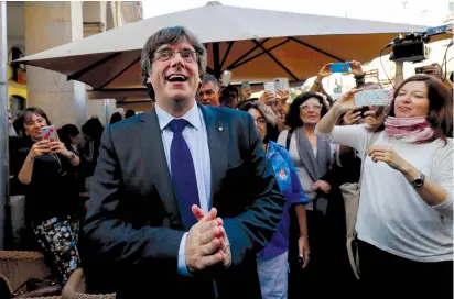  ?? (Rafael Marchante/Reuters) ?? SACKED CATALAN President Carles Puigdemont gestures after leaving a restaurant the day after the Catalan regional parliament declared independen­ce from Spain in Girona, Spain last month.