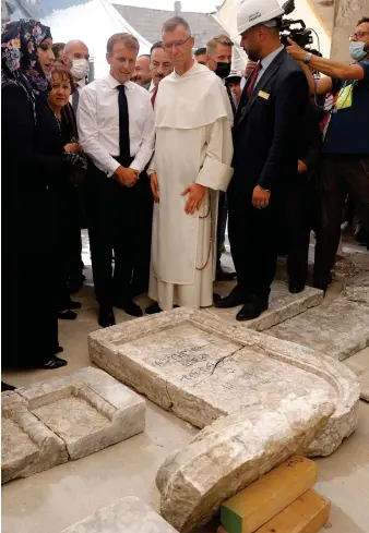  ?? AFP ?? French President Emmanuel Macron tours the Our Lady of the Hour Church on Sunday in Iraq’s second city of Mosul.