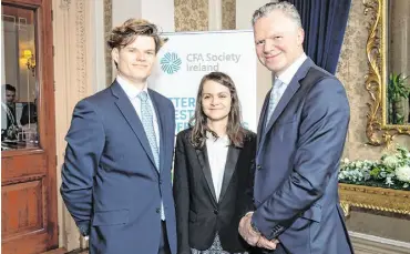  ??  ?? There has been a big rise this year in the number of people opting to start a career in the world of finance and investment. At a ceremony last week, 47 young people were conferred with their CFA charters by Chartered Financial Analysts Ireland, the Irish arm of the global CFA Institute. This is a big increase on the 35 who received their CFA charters in 2018 and brings the number of Irish CFA charterhol­ders to more than 500. Pictured at the conferring are new CFA charterhol­ders Cillian Hilliard, of Bettystown, Co Meath and Ana Ghita, from Romania, with NTMA chief executive Conor O’Kelly who gave the keynote address at the conferring ceremony.