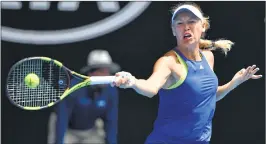  ??  ?? Caroline Wozniacki hits a return against Magdalena Rybarikova in Melbourne on Sunday.