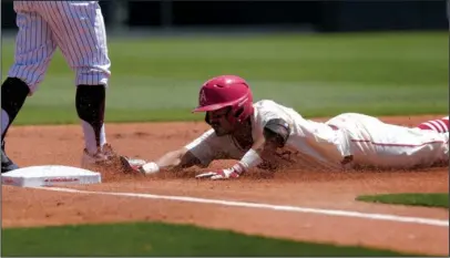  ?? NWA Democrat-Gazette/Ben Goff ?? AGGIE AGITATION: Arkansas shortstop Michael Bernal reaches third base on an RBI triple against Texas A&M during the second inning Sunday at Baum Stadium in Fayettevil­le. The Aggies won 6-2 to take the weekend series two of three.