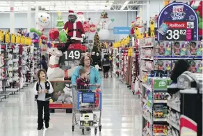  ?? DAVID J. PHILLIP/THE ASSOCIATED PRESS ?? Walmart saw a 43-per-cent increase in online sales in the U.S. during the latest quarter.