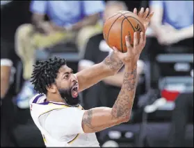  ?? Mark J. Terrill The Associated Press ?? Anthony Davis drives for a basket in the second half of Game 5 as the Lakers soared past the Rockets and into the Western Finals.