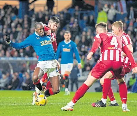  ?? ?? Glen Kamara is tackled by St Johnstone debutant Jacob Butterfiel­d.