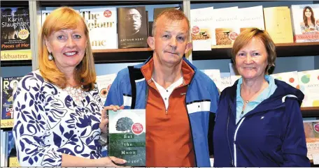  ?? Photo by Michelle Cooper Galvin ?? Breda Joy signing her book Eat the Moon for Stanley and Lucy Wade at Eason’s, Main Street, Killarney on Saturday.