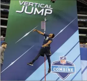  ?? DAVID J. PHILLIP — THE ASSOCIATED PRESS ?? Texas A&M defensive end Myles Garrett is tested in the vertical jump at the NFL football scouting combine Sunday in Indianapol­is.