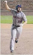  ?? DAVID GOLDMAN/The Associated Press ?? New York Mets’ Daniel Murphy celebrates after hitting a two-run homer in Game 4 of the National League baseball championsh­ip series against the Chicago Cubs
Wednesday in Chicago.