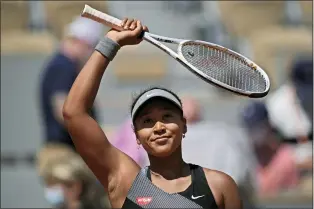  ?? CHRISTOPHE ENA — THE ASSOCIATED PRESS FILE ?? Japan’s Naomi Osaka celebrates after defeating Romania’s Patricia Maria Tig during a first-round match of the French Open at Roland Garros stadium in Paris, May 30, 2021.