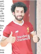  ??  ?? Iraqi footballer Hussein Ali, who plays for the Iraqi Al-Zawraa FC and is a lookalike of Liverpool’s Egyptian forward Mohamed Salah, poses for pictures in the capital Baghdad. — AFP photo