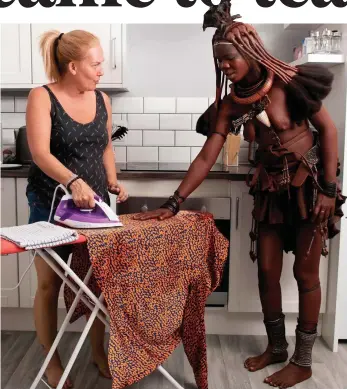  ??  ?? How we do it: Betty Moffatt introduces a Himba woman to the joys of ironing