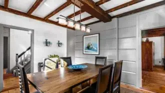  ?? ?? TOP LEFT The dining room has exposed beams, shiplap, and modern touches.