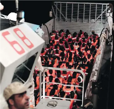  ?? KENNY KARPOV / SOS MEDITERRAN­EE VIA THE ASSOCIATED PRESS ?? Migrants prepare to board the SOS Mediterran­ée’s Aquarius ship in the Mediterran­ean. Spain has offered to take the 629 asylum seekers rescued at sea by the Aquarius after Italy and Malta refused to take them.