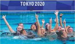  ?? AP PHOTO/MARK HUMPHREY ?? Members of the U.S. women’s water polo team wave to fans after winning their gold medal match against Spain at the Tokyo Olympics on Saturday. It’s the third straight gold medal for the Americans.
