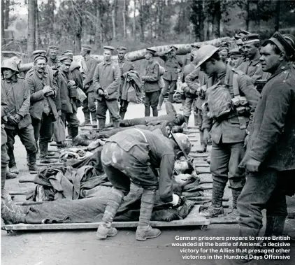  ??  ?? German prisoners prepare to move British wounded at the battle of Amiens, a decisive victory for the Allies that presaged other victories in the Hundred Days Offensive