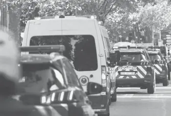  ?? THOMAS COEX/GETTY-AFP ?? French police forces escort a convoy thought to be taking Salah Abdeslam to court Wednesday.