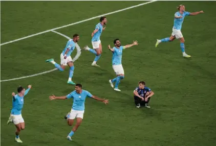  ?? ?? Manchster City players celebrate their 1-0 win at the end of the Champions League final soccer match between Manchester City and Inter Milan at the Ataturk Olympic Stadium in Istanbul, Turkey, Saturday, June 10, 2023. (AP Photo/Thanassis Stavrakis)